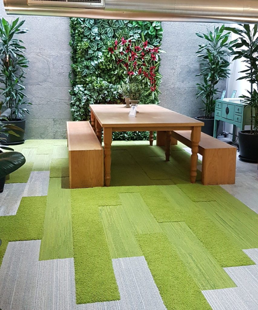Biophilic design created with a living wall and interface green carpet planks