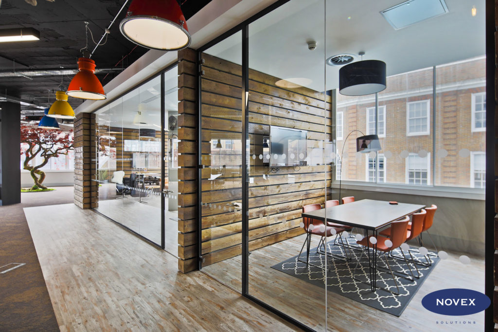 Rustic Timber clad office partitions and full height glass doors - hello games office